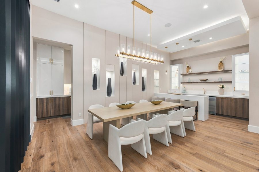 Dining room with a long table under a linear chandelier