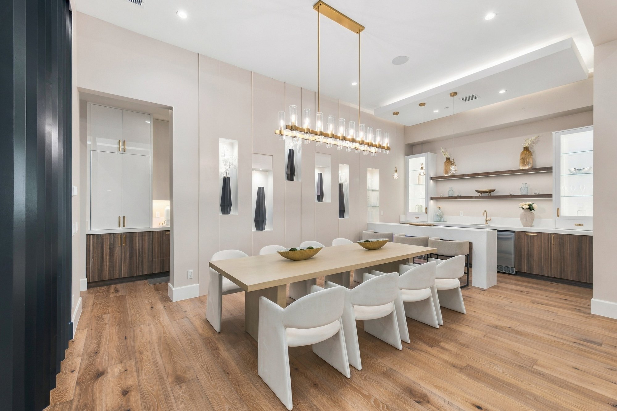 Dining room with a long table under a linear chandelier