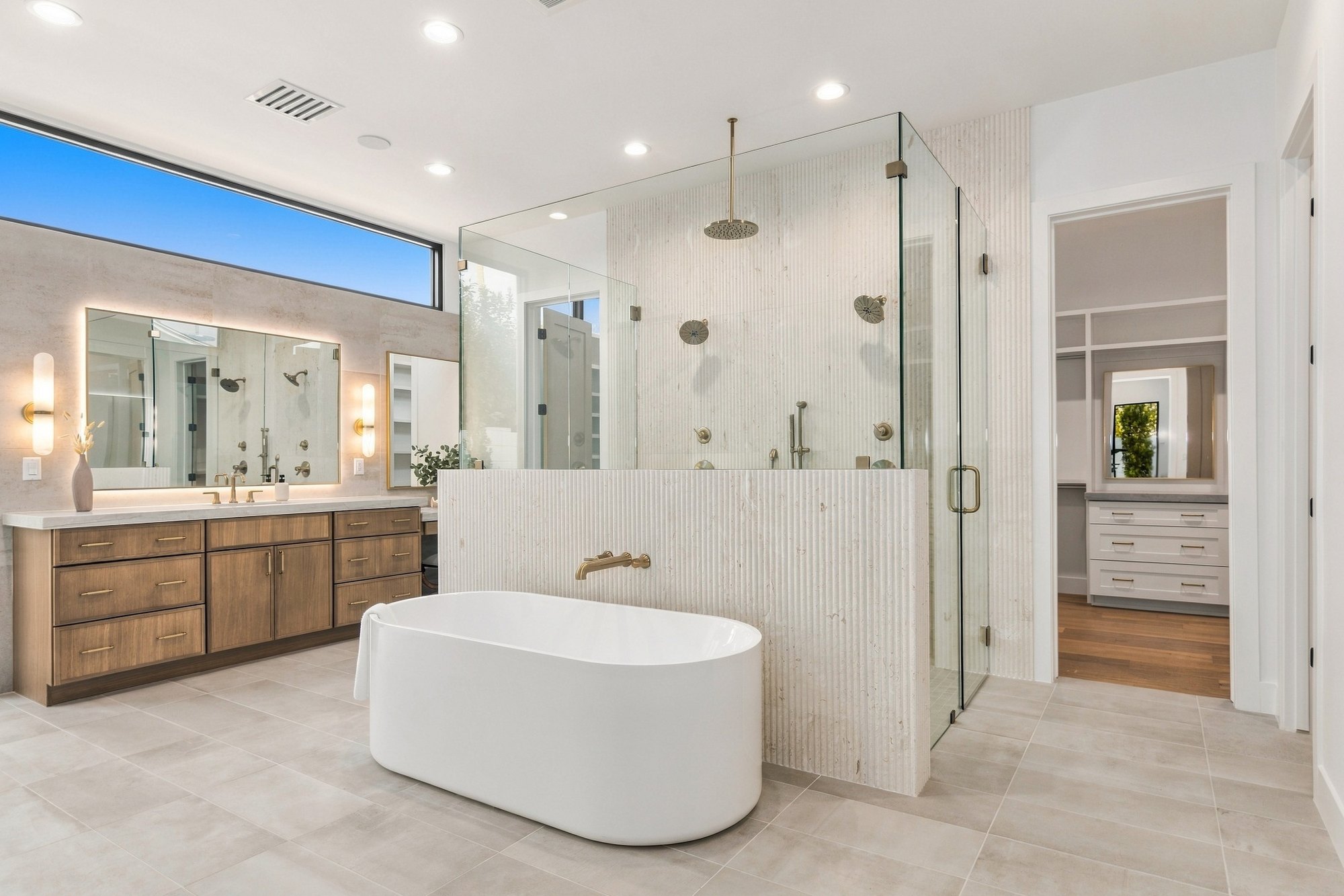 Primary bath with a freestanding tub and a glass shower